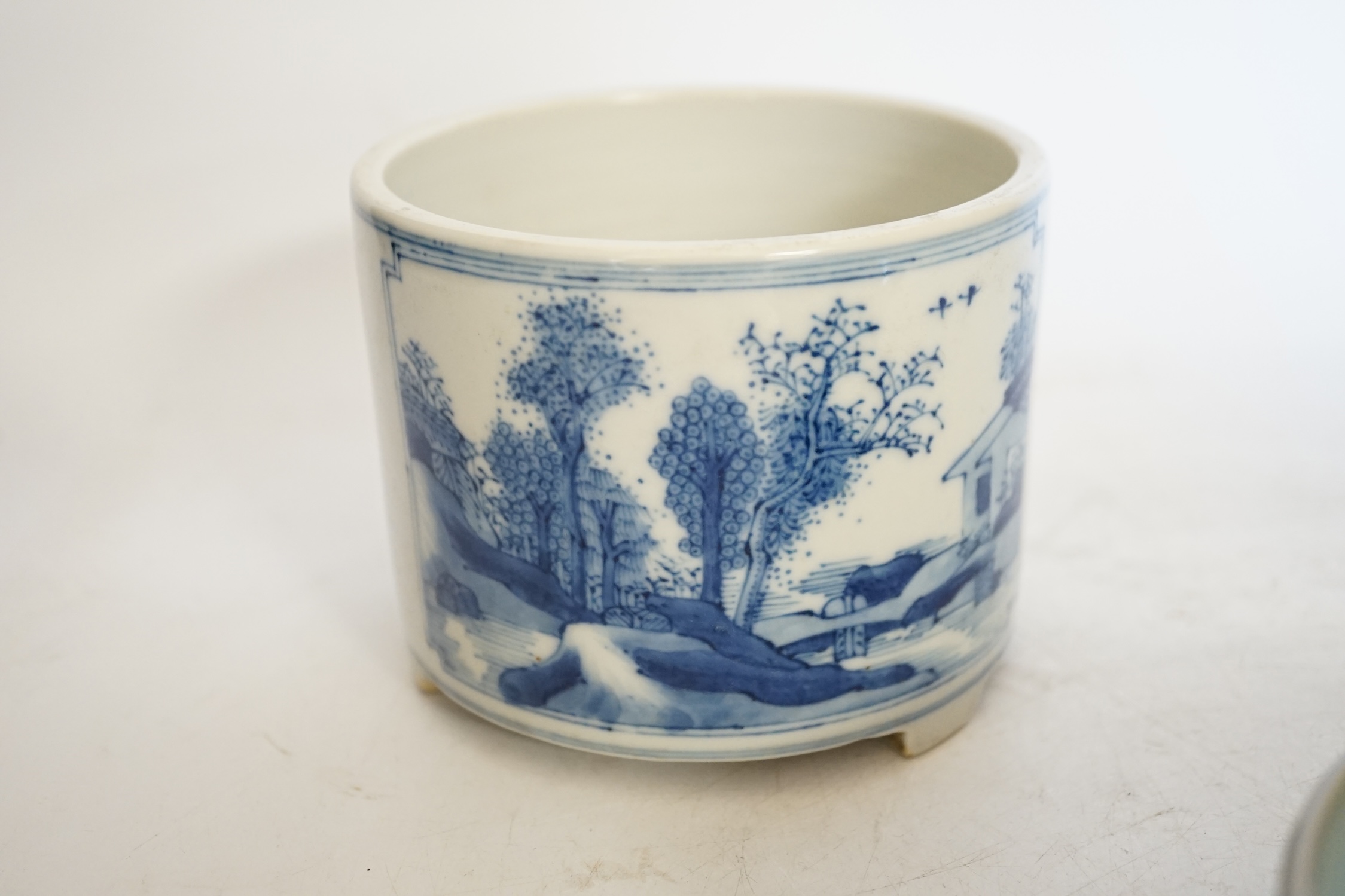A Chinese blue and white footed brushpot and celadon glazed ‘fish’ bowl, tallest 9cm. Condition - good